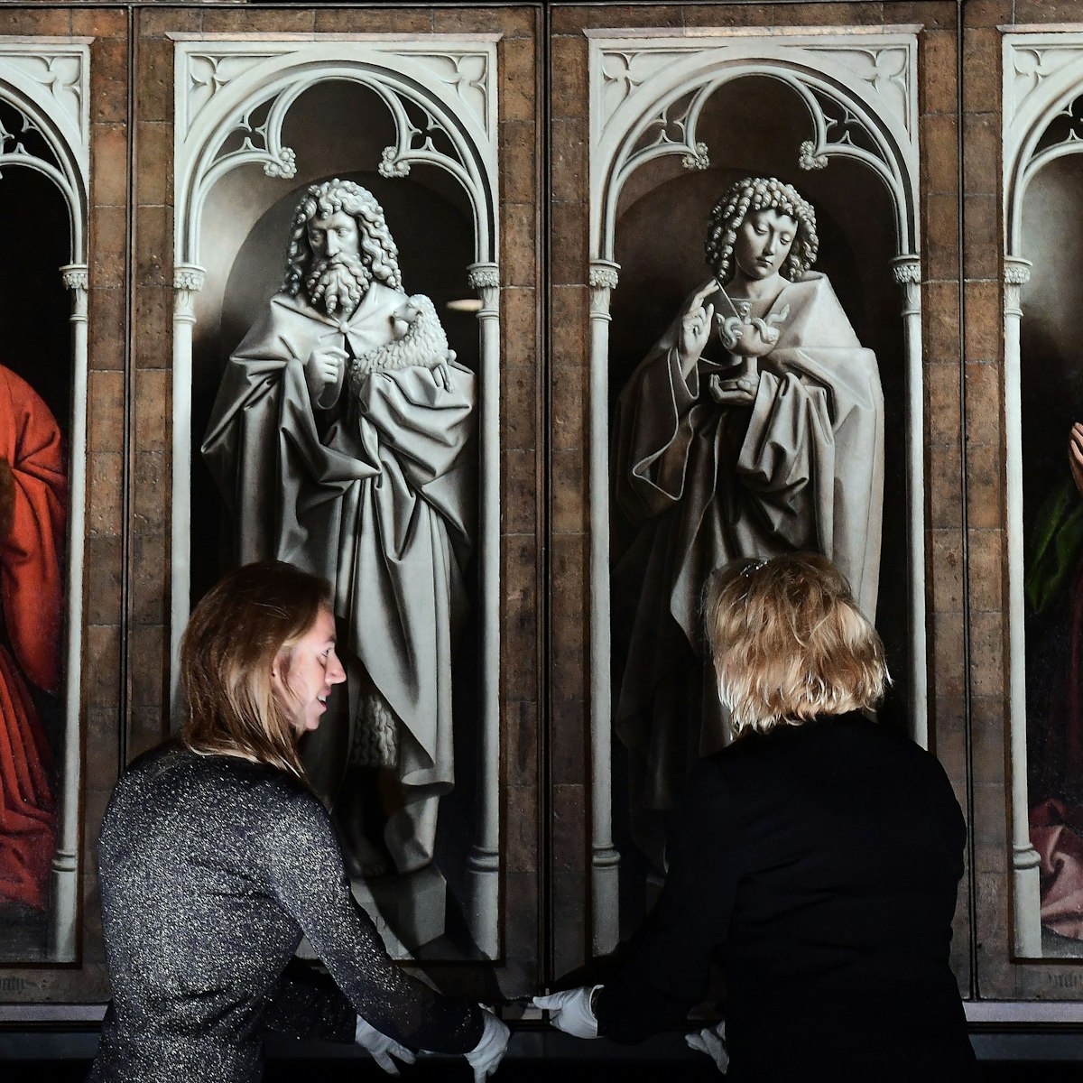 Officials unveil the restored exterior panels of "The Adoration of the Mystic Lamb", an altar piece painted by the Van Eyck brothers in 1432, at Saint Bavo Cathedral in Ghent on October 12, 2016. .The restoration of the exterior panels and frames started in 2012, and constitutes the first phase of restauration which will be followed by two other phases for the interior panels and is set to last until 2020. / AFP / EMMANUEL DUNAND (Photo credit should read EMMANUEL DUNAND/AFP/Getty Images)