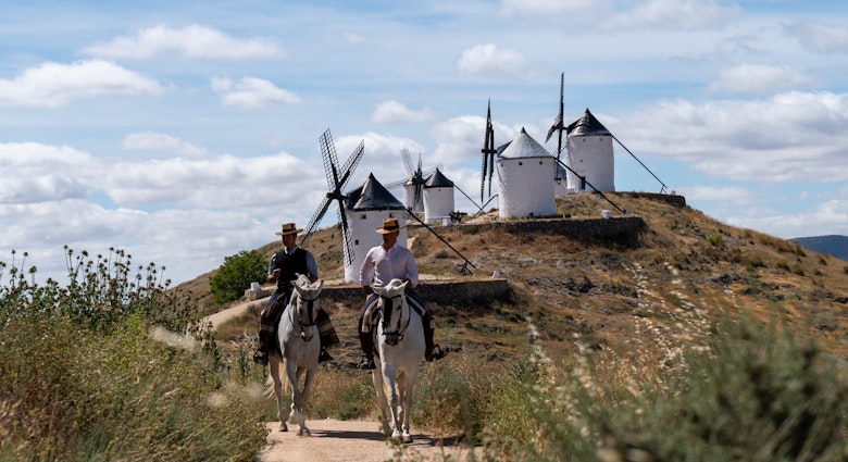 May 16, 2024: We started the day at the Centro Ecuestre Los Caireles. There we met our hosts Miguel Angel and his brother Jesus, who own and run the farm. (Miguel Angel wore a black vest.) The Centro is a horse back riding school. We shot pics at their farm and then headed to the town of Consuegra. On the mountain overlooking the town, there is a castle and several windmills. We shot pics and video of Miguel Angel and Jesus riding around the windmills and the castle. This area is notable because it is where the fictional Don Quixote rode around in Miguel de Cervantes’ famous novel. Afterward, we returned back to El Centro where we filmed our hosts riding by grape vineyards and olive groves to the nearby Villafranca de los Caballeros lagoons.
Spain Marketing 1379722