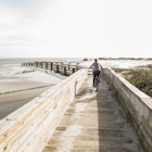 teen girl on her bike crossing bridge to the beach, St. Simon's Island, Georgia
1212071071
boy, cycle, encounter with nature, georgia, leisure, male, sandy beach, walkway, wood
Girl biking on boardwalk on Jekyll Island