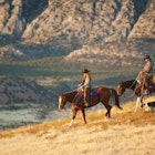 97765123
35-39 years, america, american symbol, americana, canyon, caucasian ethnicity, color image, country, countryside, cowboy, day, dog, domestic animal, field, full length, grass, hard, hat, herding dog, hills, horizontal, horse, horseback, mid adult men, outdoors, ranching, riders, semi arid climates, stetson, two people, western, work, working dog, wyoming, young women, 25-29 years
Two people ride horses in Wyoming